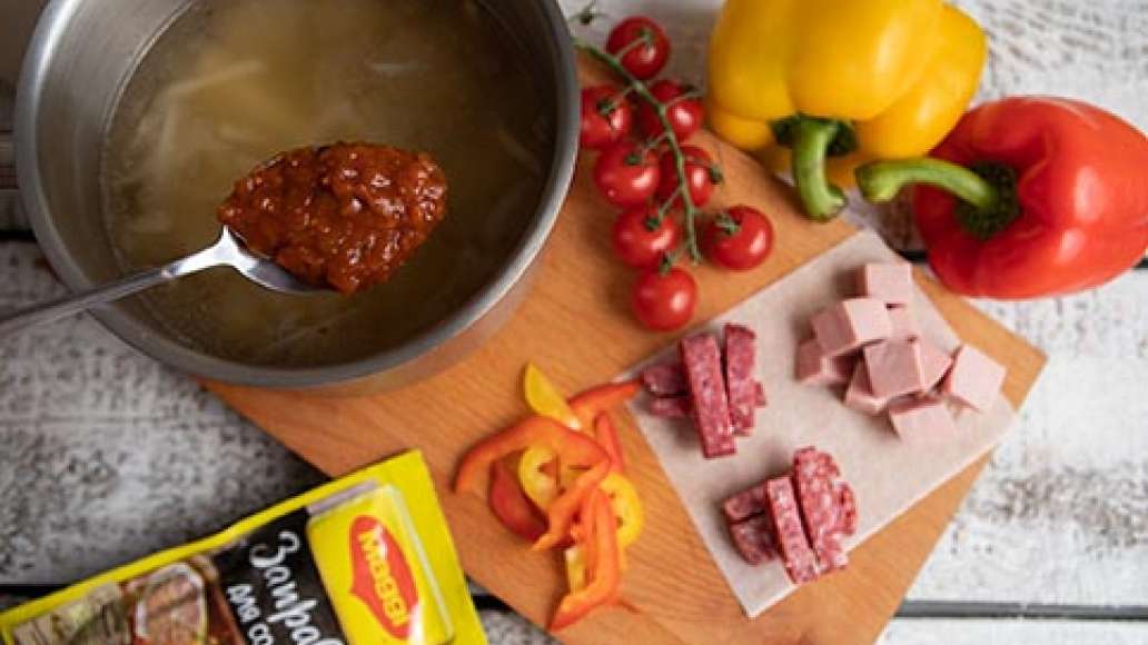 За пять минут до готовности добавить MAGGI® Заправка для солянки, нарезанную зелень, всю колбасу, помидоры. Довести до полной готовности, проверить на соль и довести до нужного вкуса.