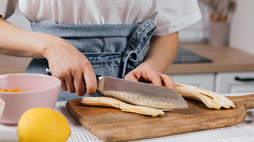 Курагу обдать кипятком и подсушить. Нарезать небольшими кусочками. Бананы очистить от кожуры и нарезать продольными ломтиками средней длины. Духовку разогреть до 180 °C.
