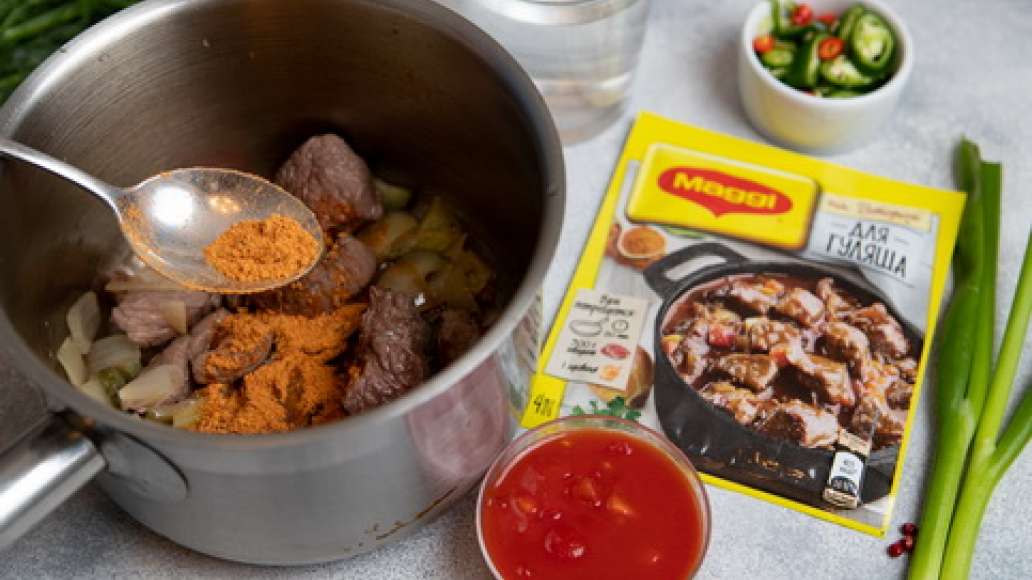 Добавить MAGGI® НА ВТОРОЕ для гуляша, воду, острый перец нарезанный колечками, помидоры в собственном соку. Тушить до готовности.