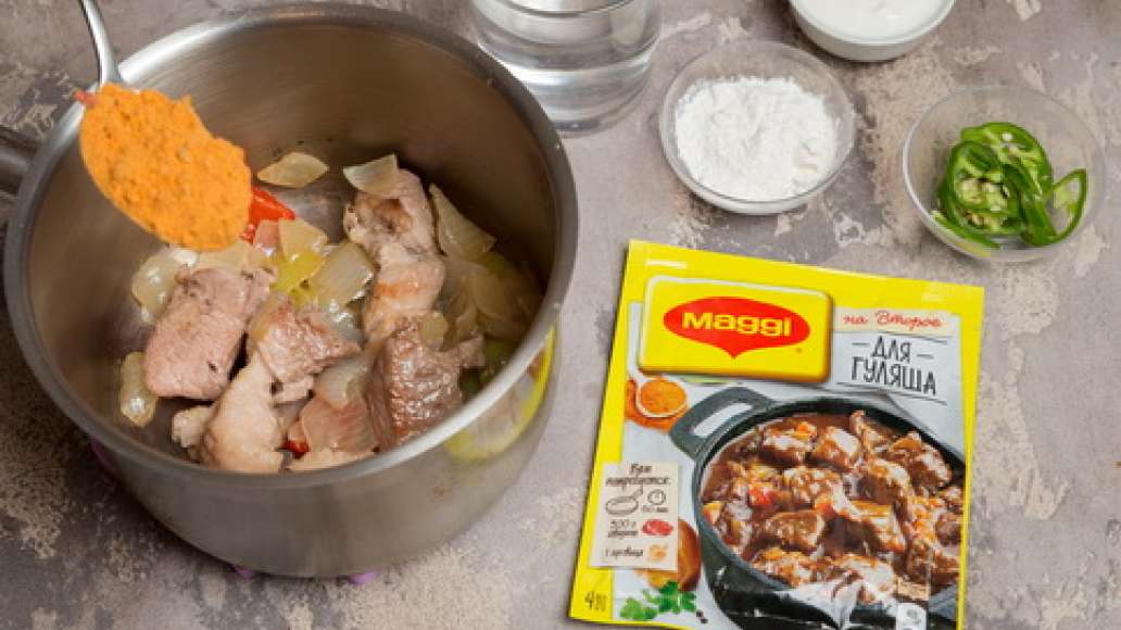 Добавить MAGGI® НА ВТОРОЕ для гуляша, воду, помидоры в собственном соку, муку и сметану. Тушить до готовности.