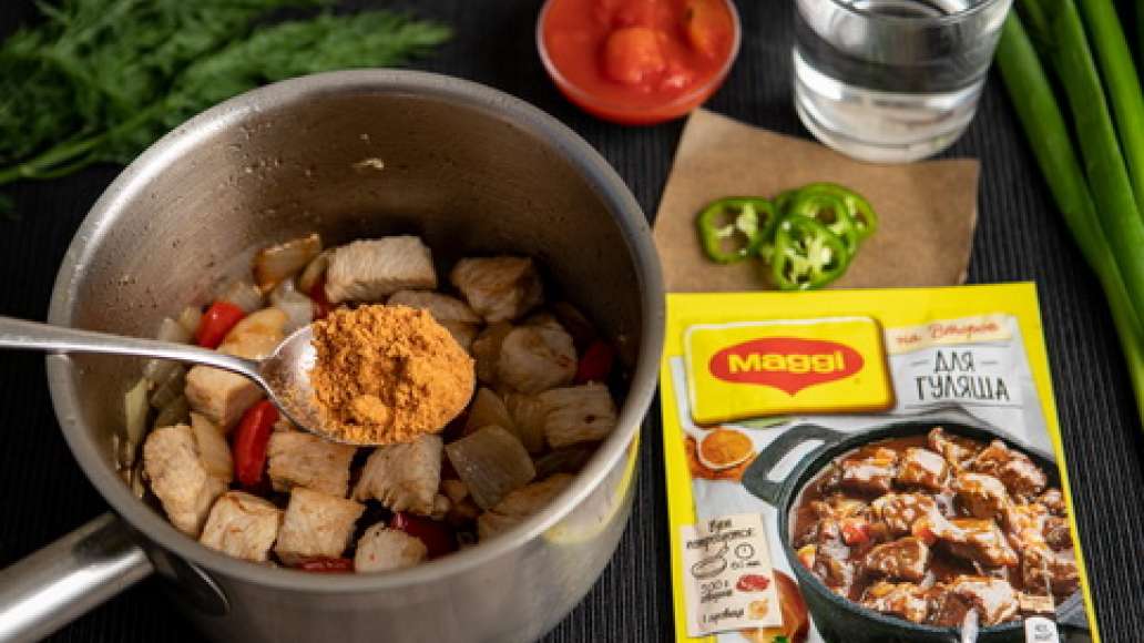 Добавить MAGGI® НА ВТОРОЕ для гуляша, воду, острый перец, нарезанный колечками, и помидоры в собственном соку. Тушить до готовности.